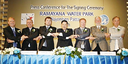 Chumpol Silapa-archa, the Minister Of Tourism & Sports, center, along with Ramayana Water Park and WhiteWater West Industries representatives shake hands at a press conference held April 8 at the Inter Continental Hotel in Bangkok to announce development plans for the water-park project.